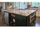 Kitchen island with built-in microwave, granite countertop, and custom storage at 1885 Dayron Trce, Marietta, GA 30062