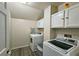 Efficient laundry room with modern appliances, storage cabinets, and practical design at 1885 Dayron Trce, Marietta, GA 30062