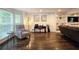 Cozy living room featuring hardwood floors, bay windows, and custom built-in shelving at 1885 Dayron Trce, Marietta, GA 30062
