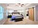 Spacious bedroom features tray ceiling, ceiling fan, carpet floor and barn door entrance at 1885 Dayron Trce, Marietta, GA 30062