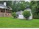 Well-maintained shed in a spacious backyard setting, with mature trees and green lawn at 1885 Dayron Trce, Marietta, GA 30062