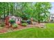 Backyard featuring a storage building, play set, and lawn at 220 Foxley Way, Roswell, GA 30075