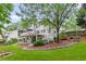 Expansive backyard featuring a multi-level deck, patio, mature trees and meticulous landscaping at 220 Foxley Way, Roswell, GA 30075