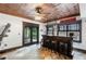 Basement bar area features an industrial style ceiling, tile flooring and French doors leading to the backyard at 220 Foxley Way, Roswell, GA 30075