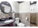Bathroom featuring multicolored tile, a dark vanity, toilet and walk-in shower at 220 Foxley Way, Roswell, GA 30075