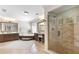 A bathroom featuring a glass enclosed shower, soaking tub and double vanity with neutral colors at 220 Foxley Way, Roswell, GA 30075