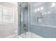 Elegant bathroom featuring tiled shower, wallpaper, and window with natural light at 220 Foxley Way, Roswell, GA 30075