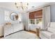 The bedroom features a large window with drapes and woven shades plus a large dresser and sitting area at 220 Foxley Way, Roswell, GA 30075