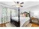 Charming bedroom with floral curtains, a canopy bed, and a ceiling fan at 220 Foxley Way, Roswell, GA 30075