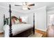 Cozy bedroom with a canopy bed, decorative pillows, and hardwood floors with rug at 220 Foxley Way, Roswell, GA 30075