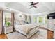 Bedroom featuring a trey ceiling, a large bed, and a dresser with a TV at 220 Foxley Way, Roswell, GA 30075
