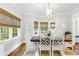 Eat in area features hardwood floors, a decorative light fixture, large windows and stylish chairs at 220 Foxley Way, Roswell, GA 30075