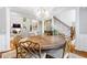 Elegant dining room with hardwood floors, designer chandelier, and an open view to the living room at 220 Foxley Way, Roswell, GA 30075