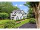 Traditional-style home showcases a manicured lawn, mature trees, and brick accents, exuding classic elegance at 220 Foxley Way, Roswell, GA 30075