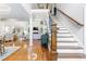 Welcoming foyer with staircase opens to a view of the living room with fireplace at 220 Foxley Way, Roswell, GA 30075