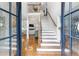 Inviting foyer features a staircase, hardwood floors, and an open view to the living room at 220 Foxley Way, Roswell, GA 30075