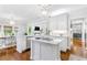 Modern kitchen boasts white cabinetry, marble countertops, stainless steel appliances, and a center island at 220 Foxley Way, Roswell, GA 30075