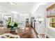 Bright kitchen features white cabinets, stainless steel appliances, hardwood floors and a center island at 220 Foxley Way, Roswell, GA 30075