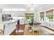 Eat in area features white cabinets, stainless steel appliances, hardwood floors and windows at 220 Foxley Way, Roswell, GA 30075