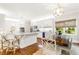 Bright kitchen features white cabinets, stainless steel appliances, hardwood floors, an island and eat in area at 220 Foxley Way, Roswell, GA 30075