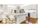 Modern kitchen features a large island with seating, stainless steel appliances, and ample cabinet space at 220 Foxley Way, Roswell, GA 30075