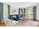 Cozy living room with a tufted blue sofa, stylish decor, and bright natural light at 220 Foxley Way, Roswell, GA 30075