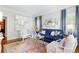 Inviting living room with hardwood floors, blue sofa, decorative art and neutral walls at 220 Foxley Way, Roswell, GA 30075