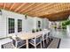 Covered patio with large dining table and chairs, perfect for outdoor entertaining at 220 Foxley Way, Roswell, GA 30075