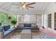 Relaxing screened porch featuring comfortable blue outdoor seating and wooded views at 220 Foxley Way, Roswell, GA 30075