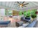 Covered porch with comfortable blue seating with a leafy view through screened windows at 220 Foxley Way, Roswell, GA 30075