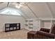 Finished attic space with built-in shelving, skylight and neutral carpeting at 2244 Deer Ridge Dr, Tucker, GA 30087