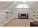 Finished attic space with built-in shelving, skylight and neutral carpeting at 2244 Deer Ridge Dr, Tucker, GA 30087