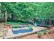 Landscaped backyard featuring raised garden beds, trampoline, and mature trees at 2244 Deer Ridge Dr, Tucker, GA 30087