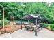 Expansive backyard featuring a covered patio, garden, and playground equipment at 2244 Deer Ridge Dr, Tucker, GA 30087