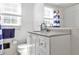 Cozy bathroom featuring a white vanity, matching toilet and shower-tub combo at 2244 Deer Ridge Dr, Tucker, GA 30087