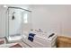 Bright bathroom featuring a soaking tub, glass enclosed shower, and black and white tile at 2244 Deer Ridge Dr, Tucker, GA 30087