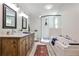 Beautiful bathroom with double vanities, a soaking tub, a separate shower, and stylish rustic wood elements at 2244 Deer Ridge Dr, Tucker, GA 30087