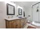 Stylish bathroom with double vanities, a walk-in shower, and elegant fixtures with a neutral color palette at 2244 Deer Ridge Dr, Tucker, GA 30087