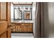 Bathroom featuring a rustic vanity with double mirrors and a shower behind a curtain at 2244 Deer Ridge Dr, Tucker, GA 30087