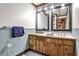 Rustic bathroom with wood paneling, double mirrors, and a wooden vanity offering vintage charm at 2244 Deer Ridge Dr, Tucker, GA 30087