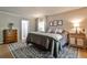 Comfortable bedroom boasts neutral tones, two large windows, hardwood floors, and stylish bedside tables at 2244 Deer Ridge Dr, Tucker, GA 30087