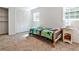 A bright bedroom features a neutral carpet, closet, and natural light from the windows at 2244 Deer Ridge Dr, Tucker, GA 30087