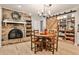 Inviting dining area features a brick fireplace, wood floors, a round table, and a convenient sliding-door pantry at 2244 Deer Ridge Dr, Tucker, GA 30087