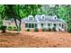 Charming brick home featuring manicured landscaping and inviting front porch; perfect blend of classic style and modern comfort at 2244 Deer Ridge Dr, Tucker, GA 30087
