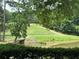 A picturesque golf course with a tranquil pond, bridge, and lush greenery, offering a serene recreational experience at 2244 Deer Ridge Dr, Tucker, GA 30087