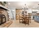 Kitchen and breakfast nook including brick fireplace, built in shelving, and hardwood floors at 2244 Deer Ridge Dr, Tucker, GA 30087