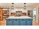 Spacious kitchen features stainless steel appliances, brick backsplash, white cabinets, and a large island with light countertops at 2244 Deer Ridge Dr, Tucker, GA 30087
