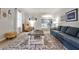 Bright living room with a large rug, ample seating, and views into dining space with ample natural light at 2244 Deer Ridge Dr, Tucker, GA 30087