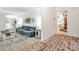 Inviting living room with wood floors, large sofa, and brick-laid hallway seamlessly connects to the dining area at 2244 Deer Ridge Dr, Tucker, GA 30087