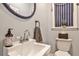 Charming powder room featuring an ornate mirror and a stylish sink and fixtures at 2244 Deer Ridge Dr, Tucker, GA 30087